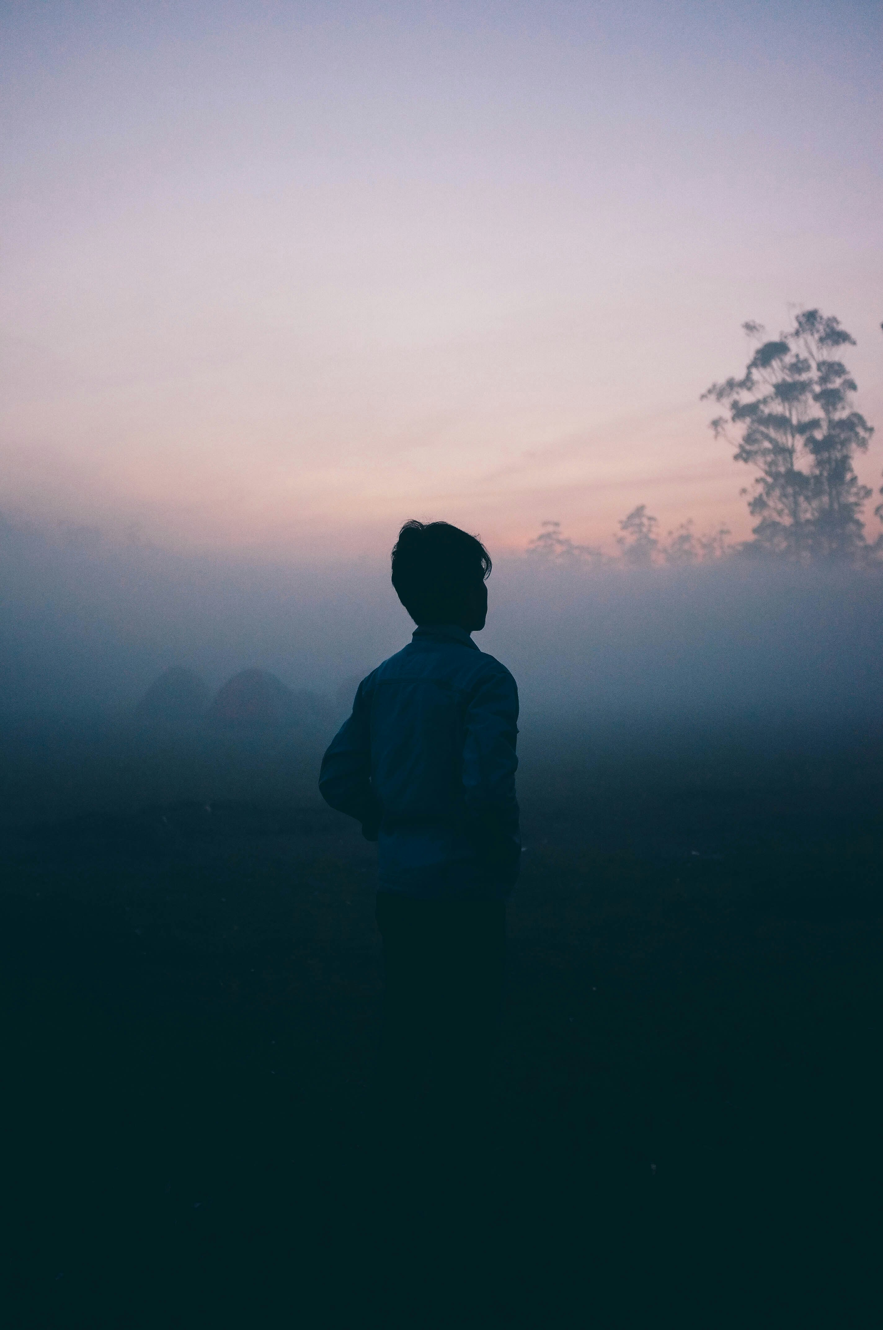 a man walks alone in the haze